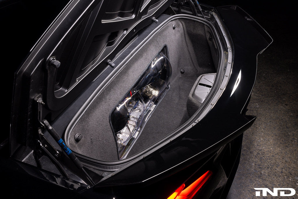 Carbon fiber intake system with curved ducts installed in vehicle front compartment area - Eventuri intake for Chevrolet Corvette Z06