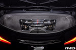 Carbon fiber intake system installed in rear engine bay with visible supercharger and mesh ducting components - Eventuri intake for Chevrolet Corvette Z06