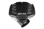 Carbon fiber inlet plenum with central V8 badge, curved design with multiple air inlet openings on sides - Eventuri inlet plenum for BMW M3