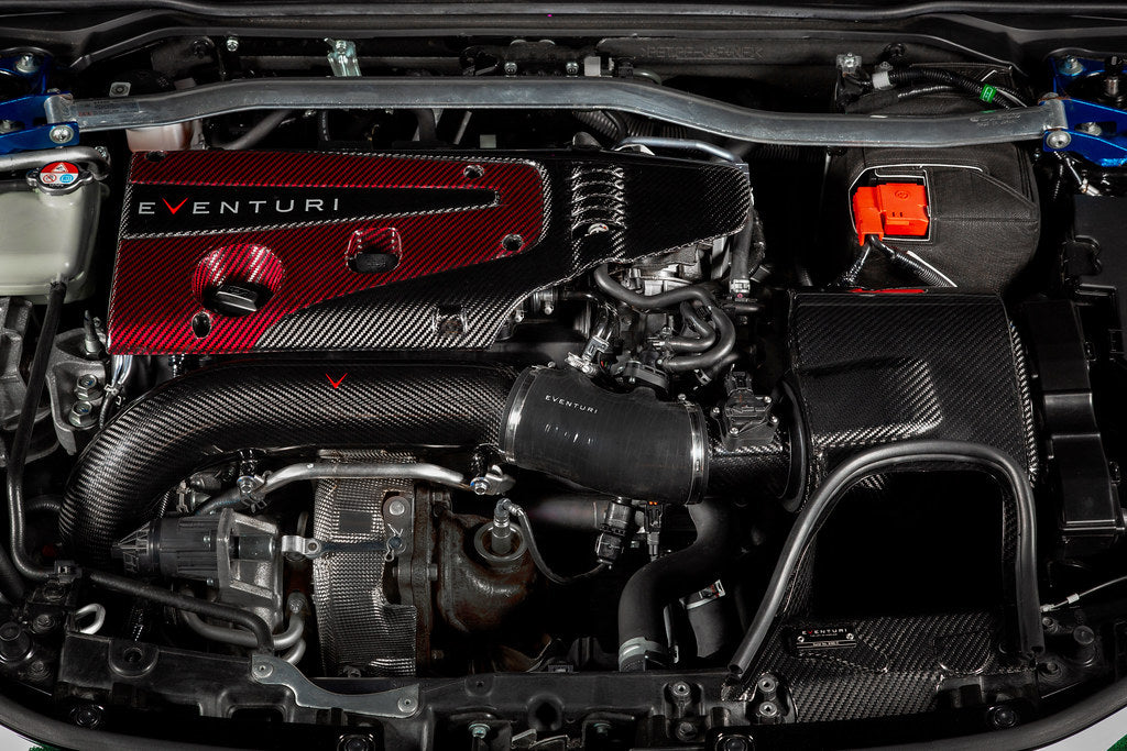 Black charge pipe with curved design installed in engine bay alongside carbon fiber intake components - Eventuri charge pipe for Honda FL5 Civic Type R