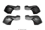 Four carbon fiber intake scoops with curved ducted design and mounting holes, displayed on white background - Eventuri intake scoop for BMW M3