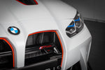 Black carbon fiber intake scoop with triangular duct design installed in white vehicle front grille opening - Eventuri intake scoop for BMW M3
