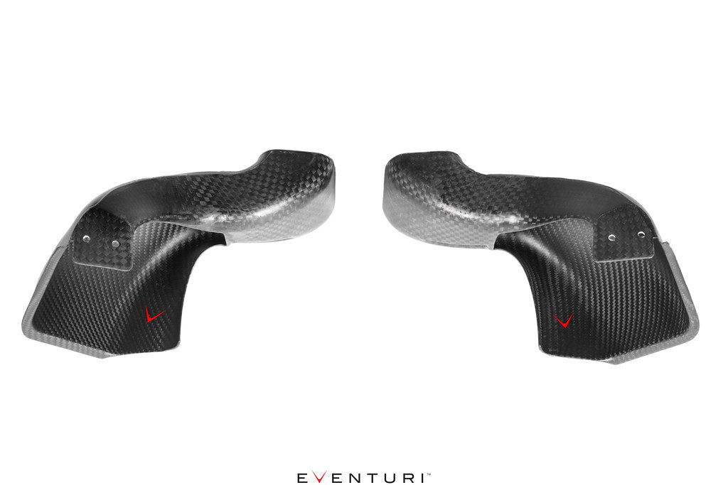Pair of curved carbon fiber intake scoops with glossy finish and mounting holes, positioned side by side - Eventuri intake scoop for BMW M3