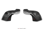 Pair of carbon fiber intake scoops with curved aerodynamic shape and mounting holes on clean white background - Eventuri intake scoop for BMW M3