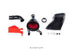 Complete carbon intake system components laid out including carbon fiber airbox, red filter, red bracket, black tube, and hardware - Eventuri carbon intake for Toyota GR Corolla