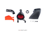 Carbon fiber intake system components laid out including curved intake tube, conical filter housing with red filter, orange heat shield, and mounting hardware - Eventuri carbon intake for Toyota GR Corolla