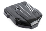 High-gloss carbon fiber engine cover for the Toyota GR Supra (3.0L), featuring a 2x2 twill weave pattern, integrated cooling vents, and silver accent stripes on a white background