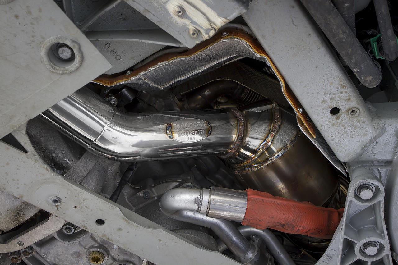 Fabspeed F12 sport cat installed beside the engine, heat shield visible