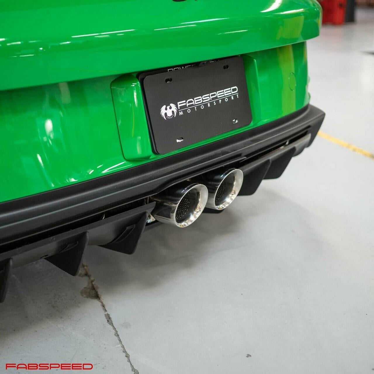 Rear of a green Porsche 992 GT3 with the Fabspeed cat-back tips