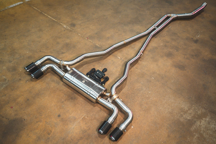 BMW G30 530i Valvetronic exhaust: angled view of the system on the shop floor with dual black tips