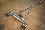 BMW G30 530i Valvetronic exhaust: angled view of the system on the shop floor with dual black tips
