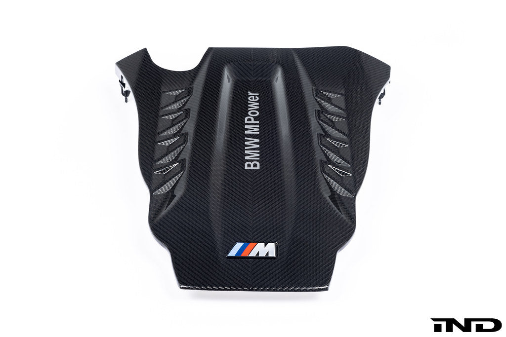 A close up view of Eventuri Black Carbon Intake System For BMW F9X X5M / X6M / G09 XM with white background