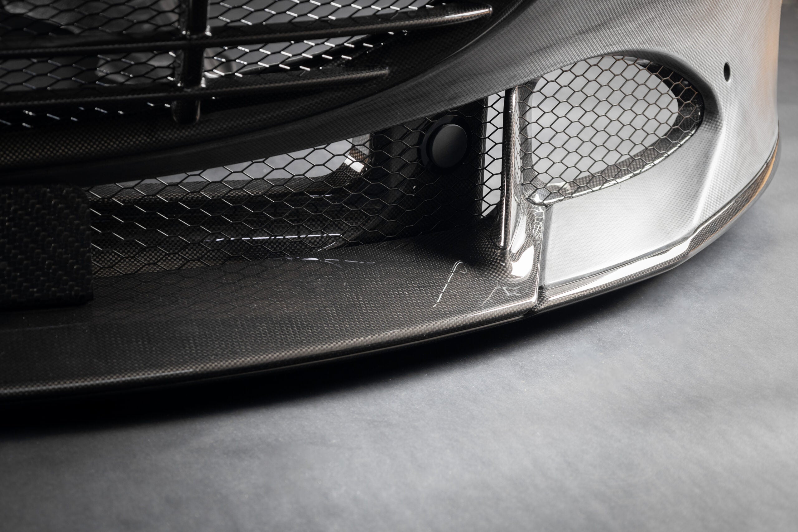 Close-up of Capristo Roma carbon bumper lower edge and mesh