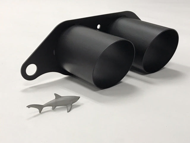 A side view of Shark Werks Light Weight Exhaust Tips for Porsche 997 / 997.2 GT3 / RS with a small toy shark with a white background