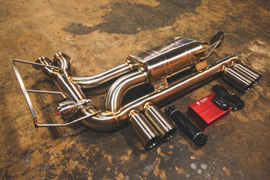 A side overview of Valvetronic Designs Valved Sport Exhaust, with wires and a red box on the ground (for BMW E46 M3).