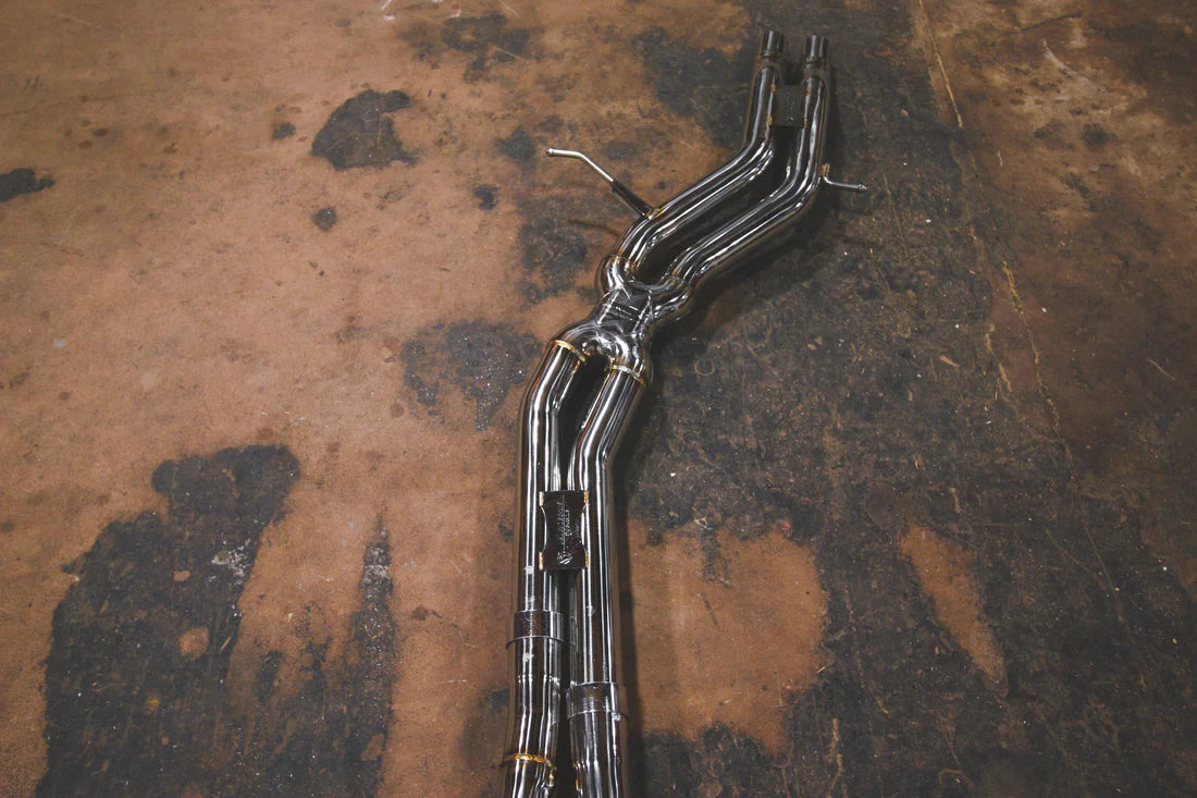 A top overview of Valvetronic Designs Valved Sport Exhaust System (for Audi B8 / B8.5 S4 / S5) pipes on the ground. 