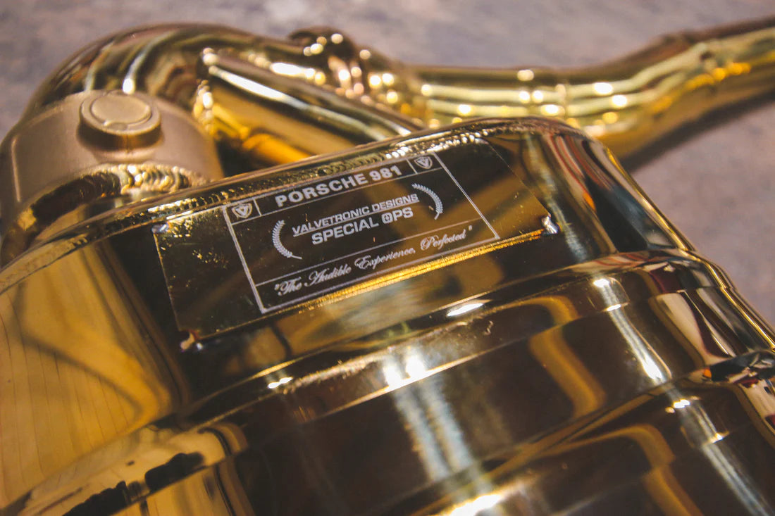 A close view of Valvetronic Designs Valved Sport Exhaust System's muffler on the ground (for Porsche Boxster/Cayman 981).