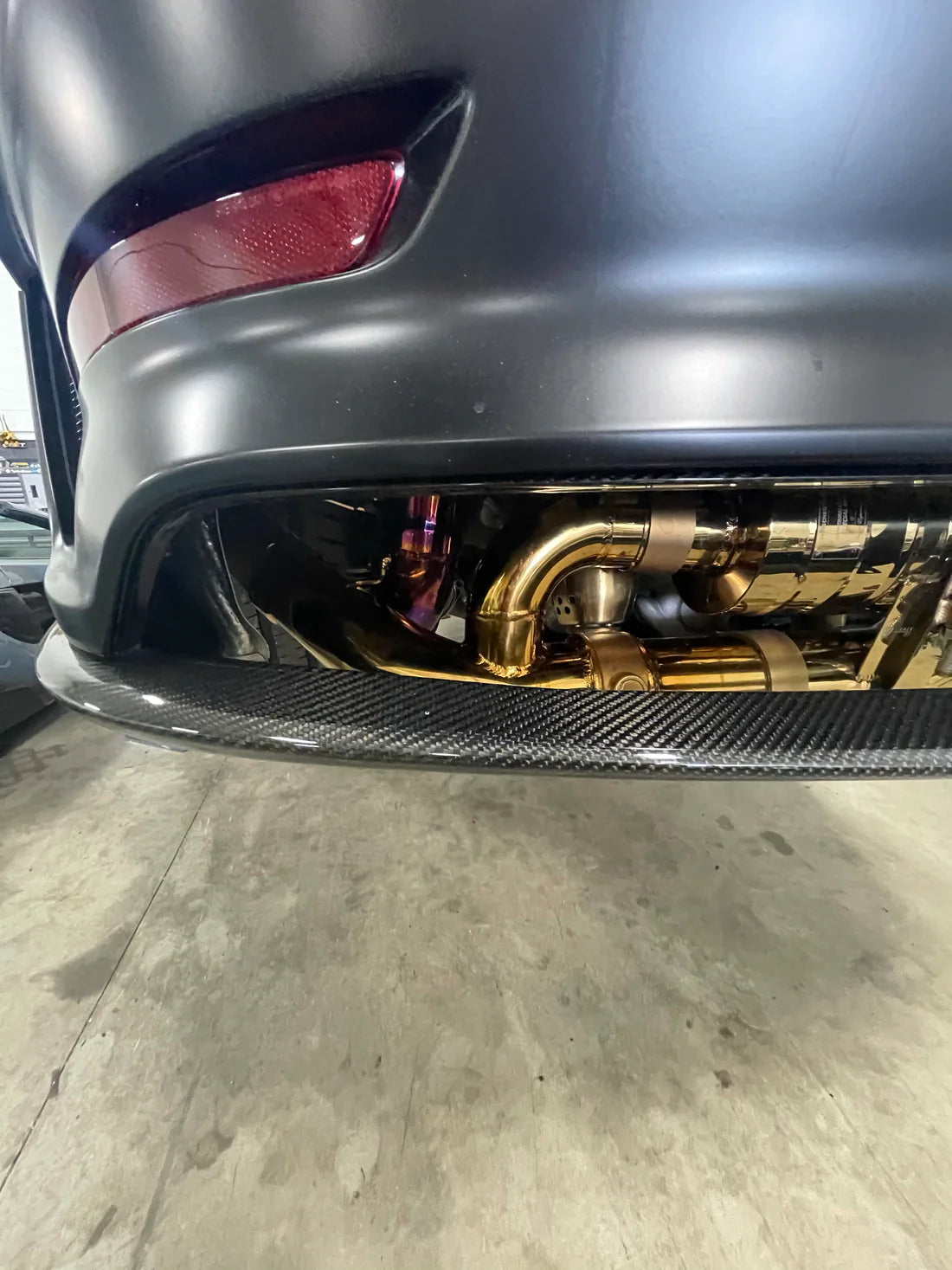 A close up view of Valvetronic Designs Valved Sport Exhaust System fitted on a car from the back (for Porsche 991 GT3 / RS).