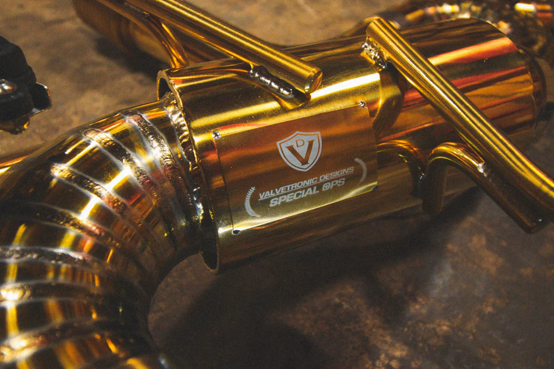 A close up view of Valvetronic Designs Valved Sport Exhaust System's pipes on the ground (for Chevrolet Corvette C8).