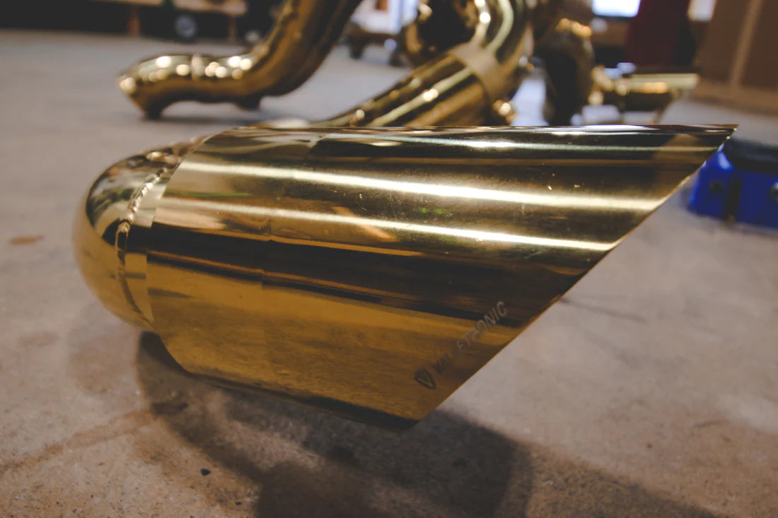 A close up view of Valvetronic Designs Valved Sport Exhaust System's exhaust tip on the ground (for Mclaren 570S / 620R).