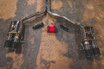 A top view of Valvetronic Designs Valved Sport Exhaust System pipes and wires (for Audi B8 / B8.5 S4 / S5) on the ground. 