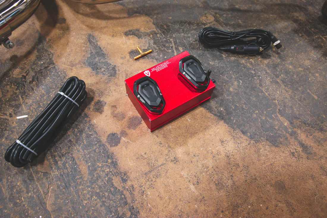 A close up of wires and read box of Valvetronic Designs Valved Sport Exhaust System (for Audi B8 / B8.5 S4 / S5) on the ground. 