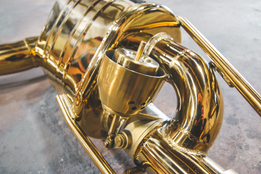 A close up of Valvetronic Designs Valved Sport Exhaust System on the ground (for Mercedes E63 AMG W212).