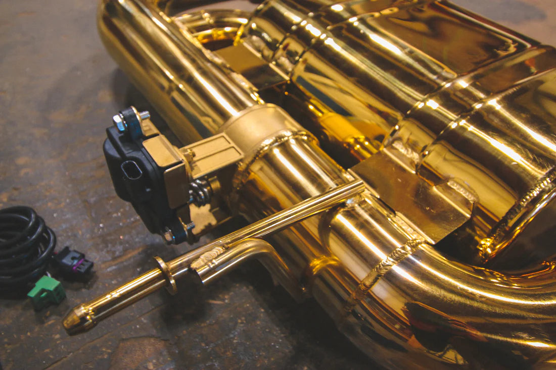 A close up view of Valvetronic Designs Valved Sport Exhaust System on the ground (for BMW i8). 