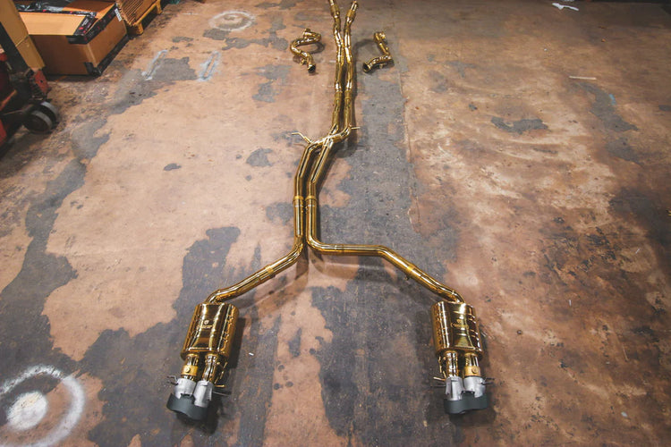 A top wide view of Valvetronic Designs gold Valved Sport Exhaust Sytem (for Audi RS6 / RS7 C7) on the ground.