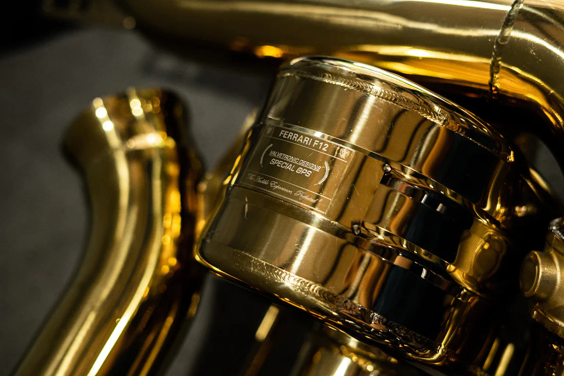 A close view of Valvetronic Designs Valved Sport Exhaust System's muffler on the ground (for Ferrari F12 / 812).