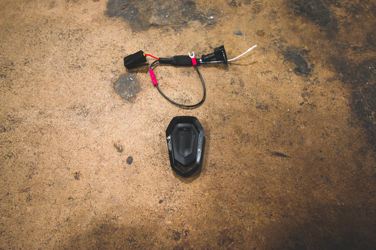 A top overview of Valvetronic Designs Porsche Exhaust Valve Controller on the ground. 