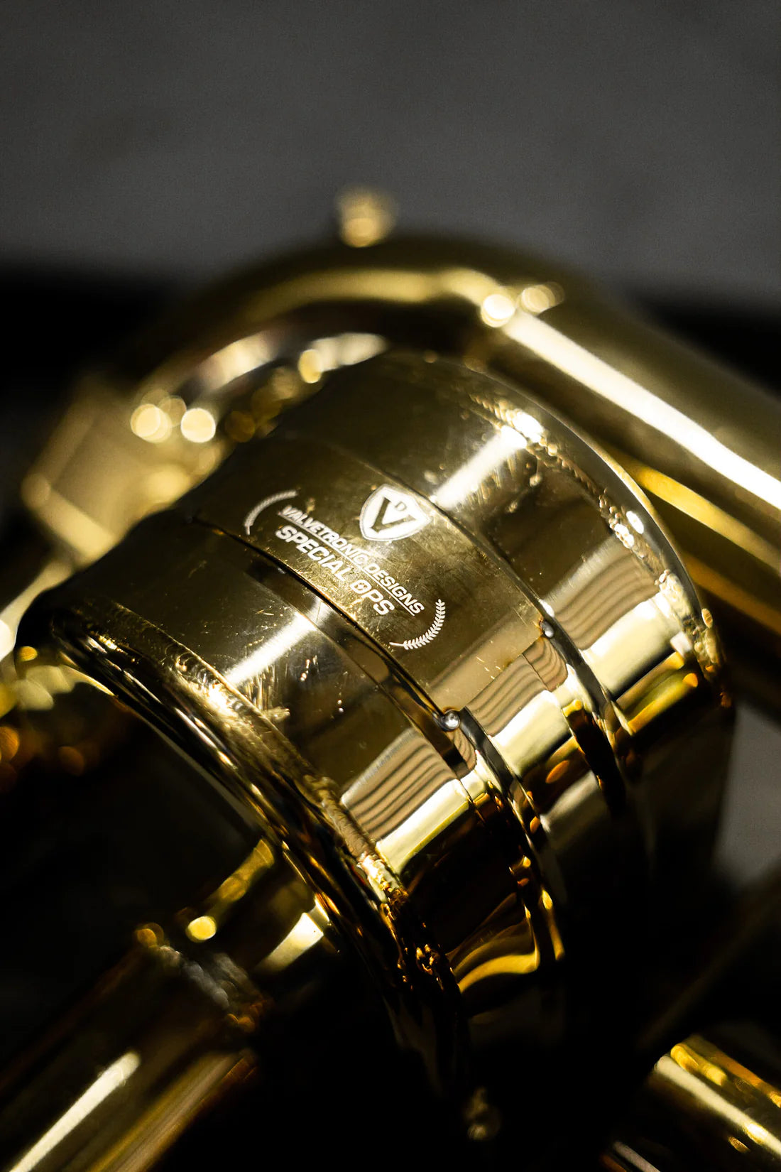 A wide view of Valvetronic Designs Valved Sport Exhaust System's muffler on the ground (for Ferrari F12 / 812).