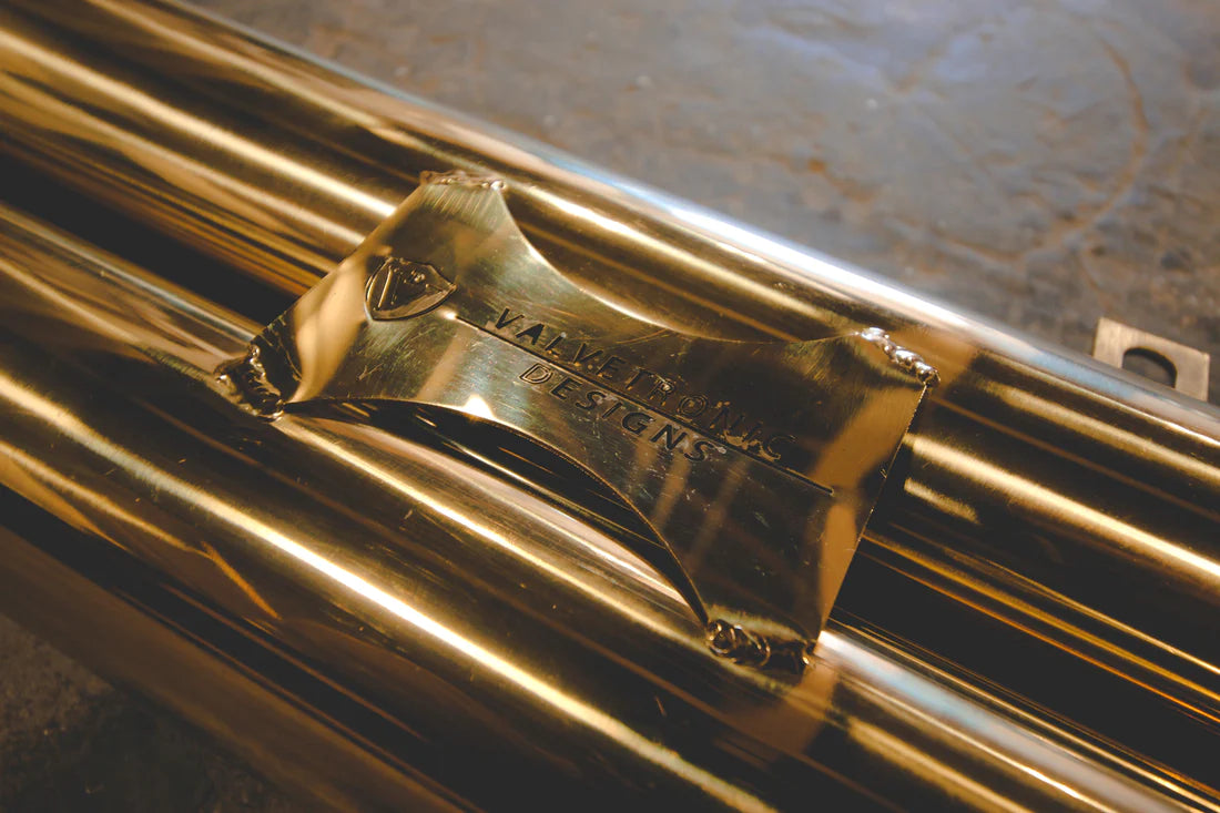 A close up view of Valvetronic Designs Stainless Steel Valved Sport Exhaust System's pipe on the ground (for Mercedes W205 C63 / C63s).