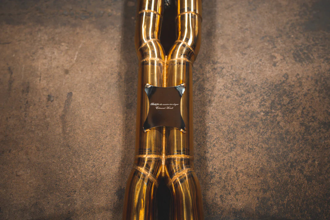 A close up view of Valvetronic Designs Ferrari Valved Exhaust system's pipes on the ground (for GTC4 Lusso)