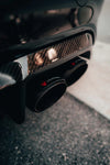 A close view of exhaust tips of Valvetronic Designs Valved Sport Exhaust System fitted on a car on the road (for BMW F87 M2).