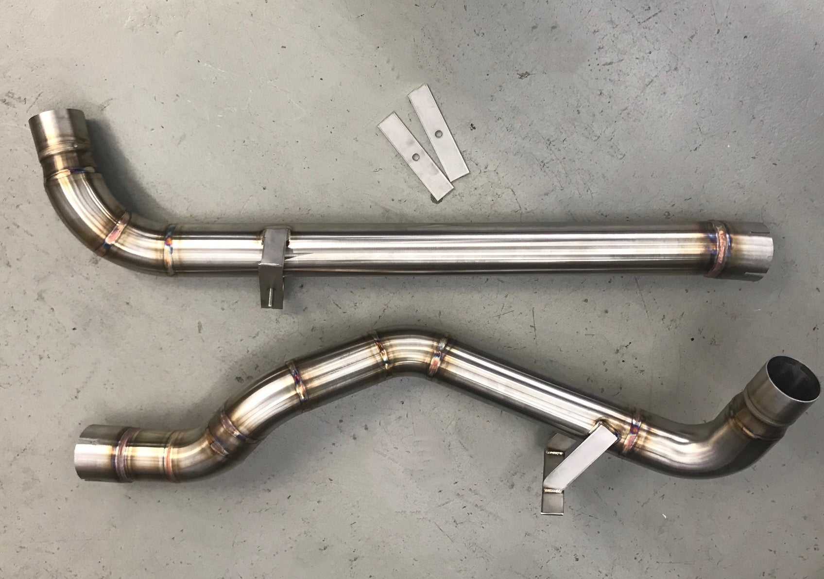 A top view of Shark Werks Sport Exhaust for Base Model (Non-PSE) for Porsche 991.2 Carrera on the ground