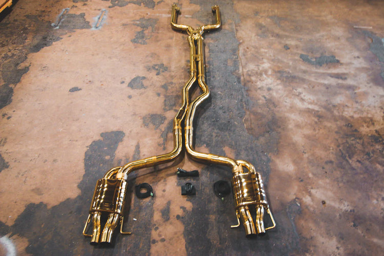A top overview of Valvetronic Designs Stainless Steel Valved Sport Exhaust System on the ground (for Mercedes W205 C63 / C63s).