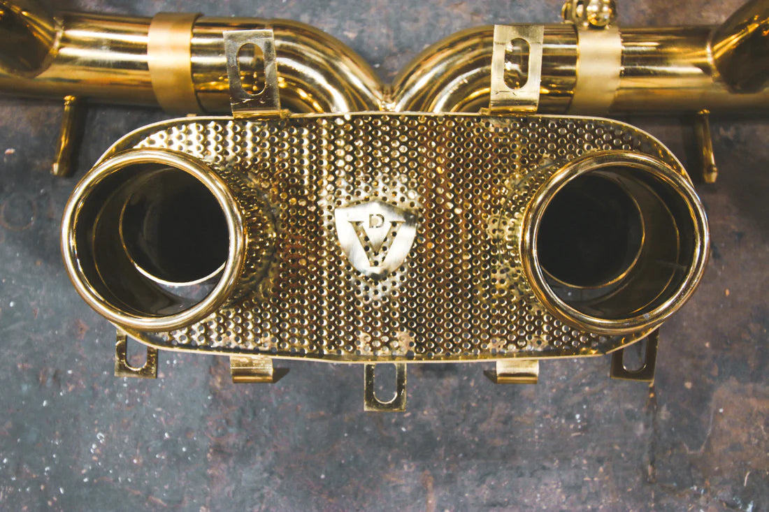 A close up of a part of Valvetronic Designs Valved Sport Exhaust System on the ground (for Ferrari 458 Italia).