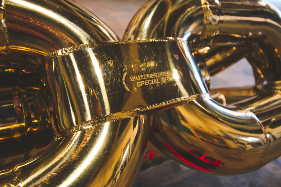 A close up view of Valvetronic Designs Valved Sport Exhaust System on the ground (for Lamborghini Huracan).