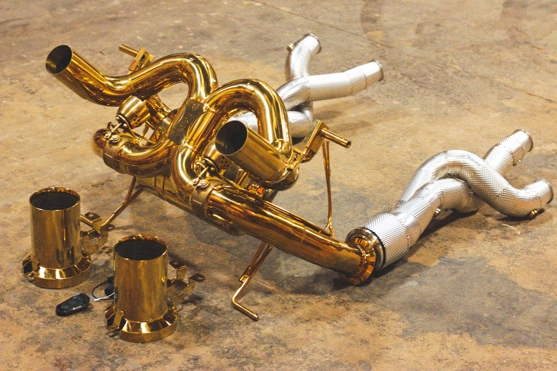 A side view of Valvetronic Designs Valved Sport Exhaust System with free flow front pipes on the ground (for Lamborghini Aventador SVJ/Ultimae).