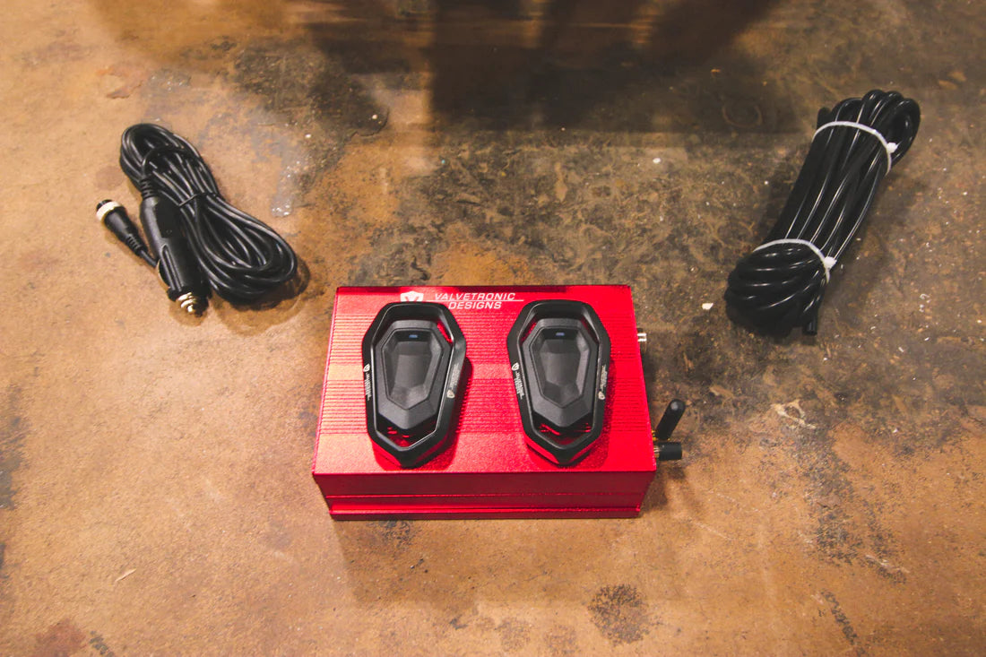 A close overview of Valvetronic Designs Valved Sport Exhaust System's valve controllers and wires on the ground (for Lamborghini Aventador LP700 / SV).