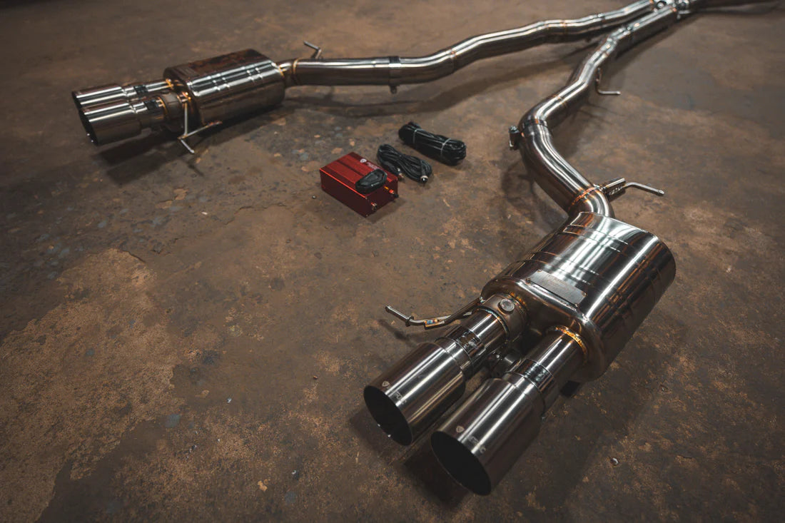 A side close up view of Valvetronic Designs Valved Sport Exhaust System on the ground (Alpina B6 / BMW 650i).