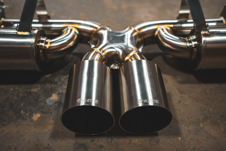 A close overview of Valvetronic Designs Valved Sport Exhaust System on the ground (for Porsche 992 GT3/ RS).