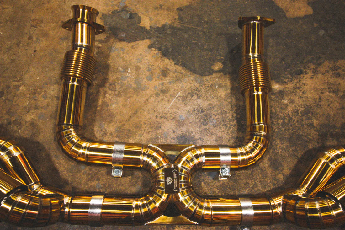 A close up view of Valvetronic Designs Valved Sport Exhaust System on the ground (for Chevrolet Corvette C8).