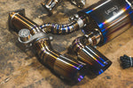 A side close up view of Valvetronic Designs Valved Race Exhaust System's exhaust tips on the ground (for Porsche 991 Turbo / Turbo S).