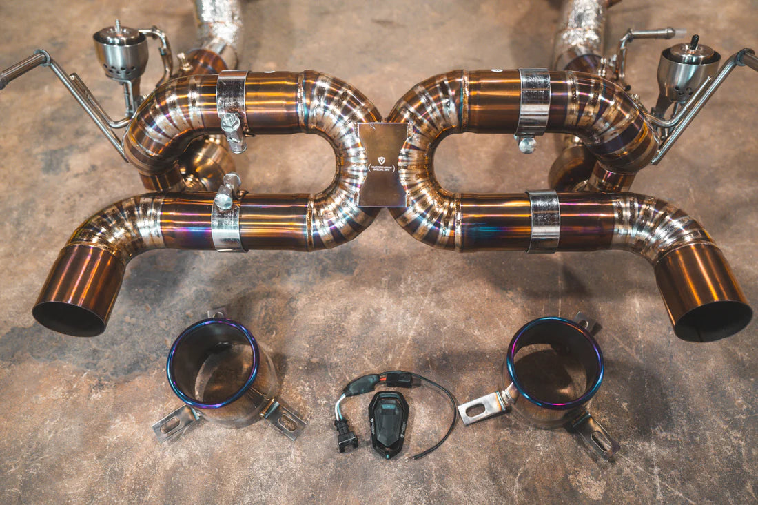 A top close up view of Valvetronic Designs Valved Sport Exhaust System with all its parts on the ground (for Ferrari F8).