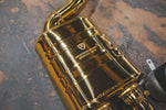A close up of parts of Valvetronic Designs gold Valved Sport Exhaust Sytem showing the brand's logo (for Audi RS6 / RS7 C7) on the ground.