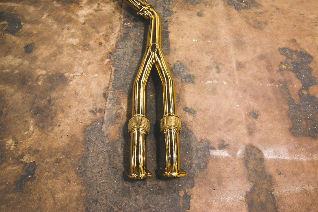 A close overview of Valvetronic Designs Valved Sport Exhaust System's pipes on the ground (for Nissan GTR R35).