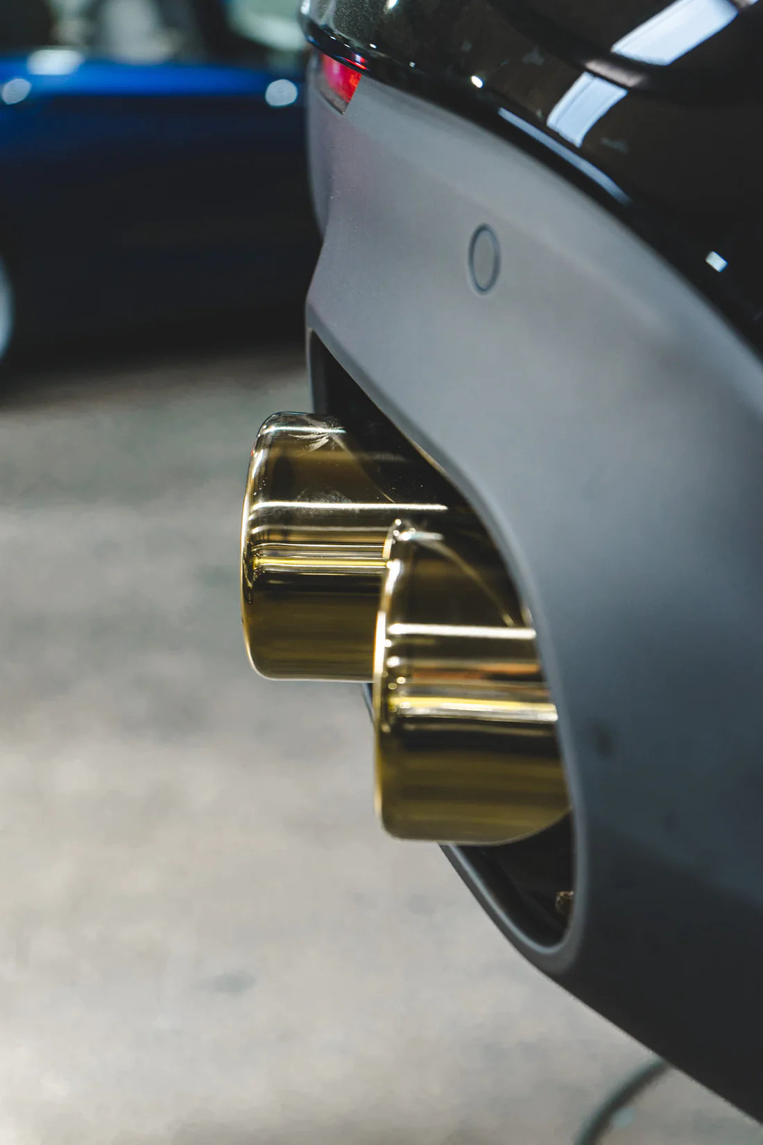 A close view of Valvetronic Designs Valved Sport Exhaust System's exhaust tips fitted on a car (for Ferrari F12 / 812).