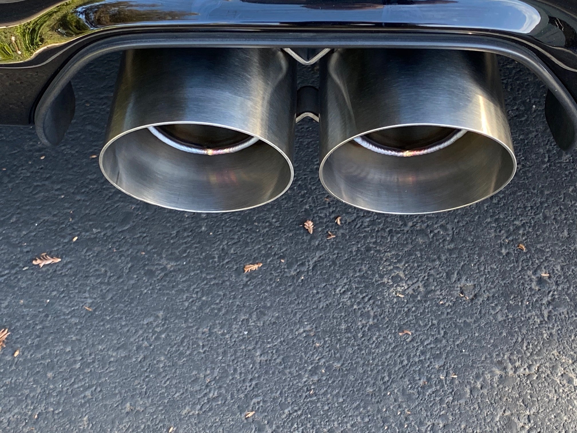A top close up view of Shark Werks Track Exhaust for Porsche 991 / 991.2 GT3 / RS exhaust tips fitted on a car outside